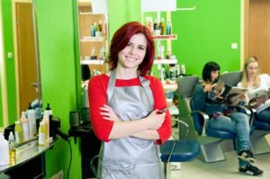 Happy hairdresser in a vibrant salon setting